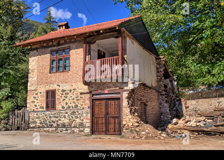 Alte beschädigt traditionellen Haus aus Stein Gebäude mit Balkon in Republik Vevčani, DER EHEMALIGEN JUGOSLAWISCHEN REPUBLIK MAZEDONIEN Mazedonien, Balkan Stockfoto