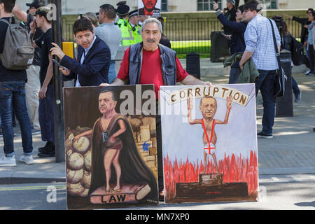 Downing Street, London, 15. Mai 2018.Künstler Kaya Mar mit zwei seiner satirischen politischen Gemälde. Anhänger des türkischen Präsidenten Erdogan sowie seine überwiegend kurdischen Gegner und andere Gegendemonstler versammeln sich vor der Downing Street und warten auf die Ankunft von Präsident Recep Tayyip Erdogan, der derzeit drei Tage lang in Großbritannien ist und heute voraussichtlich mit Premierministerin Theresa May zusammentreffen wird. Kredit: Imageplotter Nachrichten und Sport/Alamy Live Nachrichten Stockfoto