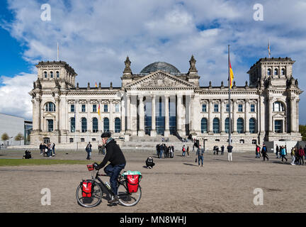 Ein Mann fährt mit dem Fahrrad vor dem Reichstag, der historischen deutschen Parlament, am 16. April 2017 in Berlin, Deutschland. Stockfoto