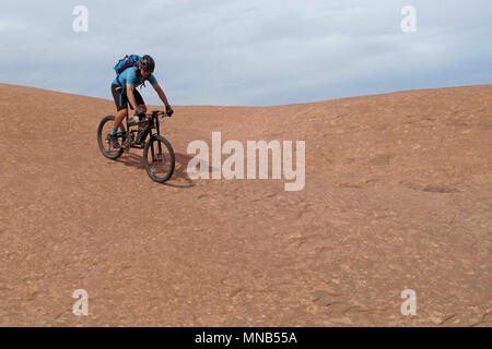 Biker Riding Downhill der berühmten Slickrock Trail, Moab, USA Stockfoto