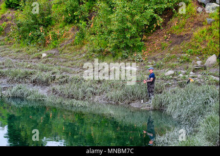 Anchorage, Alaska, USA - 30. Juni 2017: ein Fischer fischen auf Lachs an den Ufern des Ship Creek, ein Fluss in Anchorage, Alaska Stockfoto