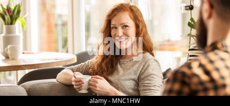 Panorama von lächelnden Frau trinkt Tee und suchen ihren Mann Stockfoto
