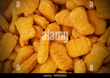 Gefrorene Nuggets verteilte sich gleichmäßig als Hintergrund. Stockfoto