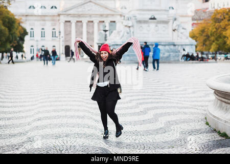 Portrait von Fröhliche Frau tanzen am Town Square gegen Gebäude in der Stadt, Lissabon, Portugal Stockfoto