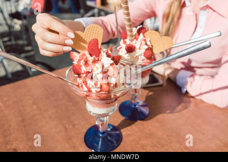 Frauen Eis essen im Restaurant an einem sonnigen Tag Stockfoto