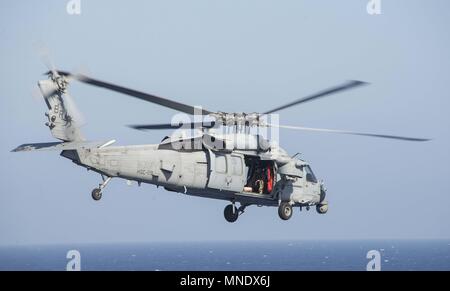 180515-N-AH 771-0081 5. US-Flotte von Operationen (15. Mai 2018) Der MH-60S Seahawk, Hubschrauber Meer Squadron (HSC) 28, weg von der Flight Deck der Wasp-Klasse amphibisches Schiff USS Iwo Jima (LHD7) während einer Auffüllung-auf-See, Mai 15, 2018, 15. Mai 2018. Iwo Jima homeported in Mayport, Florida ist für die Bereitstellung in die USA 5 Flotte Bereich für Maßnahmen zur Erhöhung der Sicherheit des Seeverkehrs Operationen Verbündeten und Partnern zu beruhigen, und der Freiheit der Schiffahrt und des freien Handels in der Region erhalten. (U.S. Marine Foto von Mass Communication Specialist 3 Cla Stockfoto