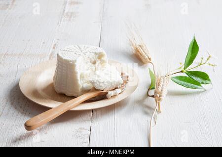 Ricotta auf einem Teller mit einem Löffel aus Holz Stockfoto