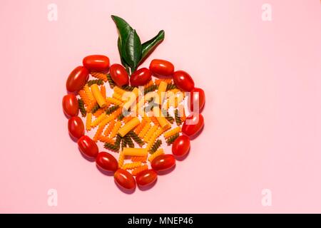 Sortierte bunte Nudeln in eine Tomate Herz Stockfoto
