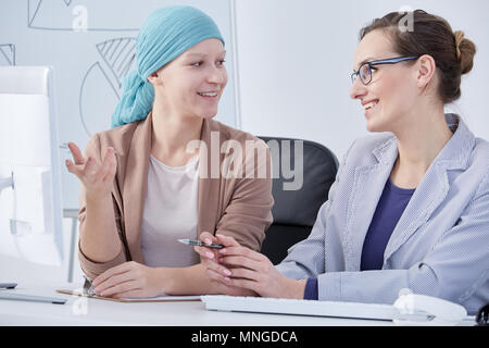 Frau nach chemo bei der Arbeit, im Gespräch mit Freund Stockfoto