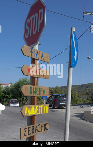 Schild mit den Namen von Siedlungen in der griechischen Sprache und die Richtung der Bewegung auf der Insel Rhodos und Stoppschild (Griechenland). Stockfoto