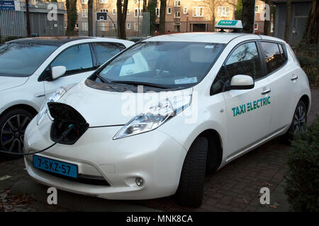 Amsterdam, Niederlande - Dezember 13,2015: Elektrische Taxi an eine Ladestation in Amsterdam. Aufladen der Akkus Stockfoto