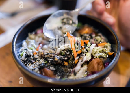 Nahaufnahme der Mahlzeit zum Mittag- oder Abendessen Gericht in japanischen traditionellen asiatischen Restaurant oder Cafe mit pflanzlichen ochazuke, Löffel, Person hand Essen Stockfoto