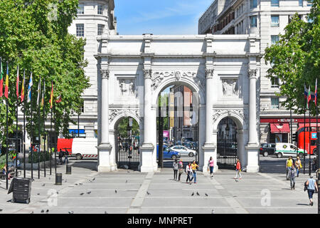 London street scene Flags einheimischen Touristen & Tauben im Marble Arch Triumphbogen in weißem Carrara-Marmor Bayswater Road Traffic über England konfrontiert Stockfoto