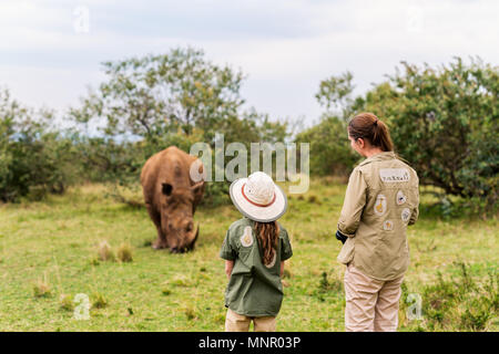 Rückansicht der Familie auf Safari zu Fuß in der Nähe von White Rhino Stockfoto