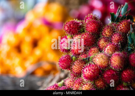Auswahl an frischen exotischen Rambutan Früchte am Marktstand Stockfoto