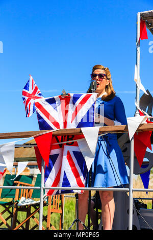 Gruß zu den 40er Jahren beliebte nostalgische Veranstaltung. Frau Sänger der Sieg der Kriegszeit Band, winken Union Jack und Singen auf dem Deck des P22 am Sandwich. Stockfoto