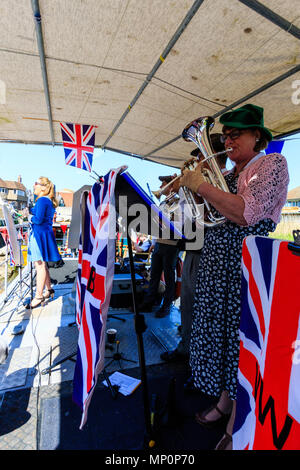 Gruß zu den 40er Jahren beliebte nostalgische Veranstaltung in England. Der Sieg der Kriegszeit Band und Frau Sänger, die auf dem Deck des Bootes mit Union Jack Fahnen. Stockfoto