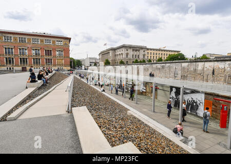 15. Mai 2018, Deutschland, Berlin: Die Besucher werden auf dem Gelände der ständigen Ausstellung "Topographie des Terrors" mit einem Teil der Berliner Mauer. Der Martin-Gropius-Bau (L) und das Abgeordnetenhaus (lit. Haus der Vertreter) der Berlin kann im Hintergrund gesehen werden. Die Ausstellung ist eine der am häufigsten besuchten Gedenkstätten in Berlin. Während des "Dritten Reiches" das Hauptquartier der Gestapo, der Schutzstaffel (SS) und des Reiches wichtigsten Security Office wurden hier entfernt. Foto: Jens Kalaene/dpa-Zentralbild/dpa Stockfoto