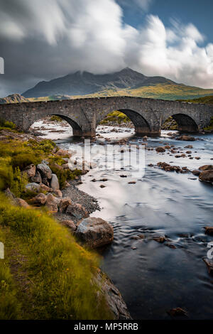 Schottische Highlands - River Sligachan und der alten Brücke, Isle of Skye, Schottland, UK mit dem Schwarzen Cuillin Berge in der Ferne Stockfoto