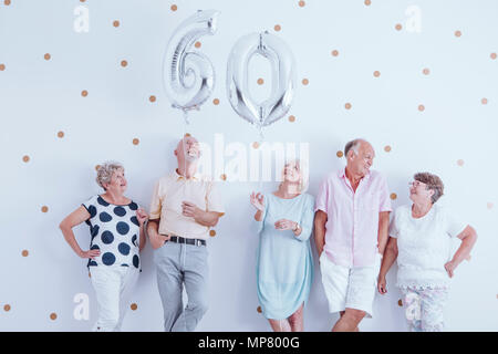 Die Gruppe der älteren Menschen gemeinsam Spaß bei einem Geburtstag Sitzung Stockfoto