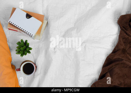 Kaffee- und Stapel Bücher auf weißen Bett. Morgen Stimmung. Stockfoto