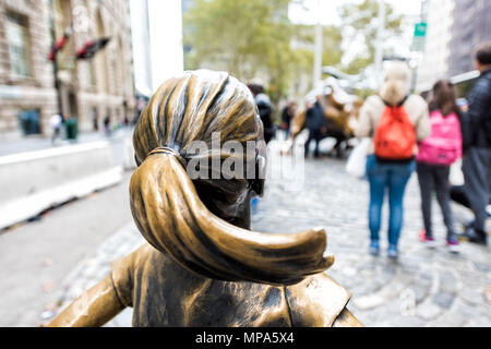 New York City, USA - 30. Oktober 2017: Wall Street Börse Der Furchtlose Mädchen Statue vor wütenden Stier Metall in NYC Manhattan geringere finanzielle Stockfoto