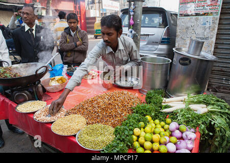 Indien, Uttar Pradesh, Lucknow, einem Anbieter bereitet einen vegetarischen Snack einschließlich mung Bean srouts an seinem Straße abgewürgt. Stockfoto