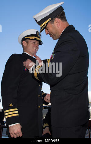 170204-N-VR594-131 NAVAL AIR STATION NORTH ISLAND, Kalifornien (3. Februar 2017) CMdR Jason M. Wood, ausgehende Kommandierender Offizier der Flotte Logistics Support Squadron (VR) 57, die "Eroberer" pins CMdR Matthew H. Morton als eingehende CO von VR-57. VR-57, eine Marine Reserve Force Staffel enthält aktiven Dienst und Reserve-Einheiten, die in der Luft-Logistik, US und Verbündete Kräfte zu unterstützen. (Foto: U.S. Navy Masse Kommunikation Spezialist Seemann Kelsey J. Hockenberger/freigegeben) Stockfoto