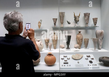 Kreta, Griechenland. 22. Mai, 2018. Ein Tourist nimmt Fotos einer Ausstellung im Archäologischen Museum in Heraklion auf Kreta, Griechenland, 22. Mai 2018. Das Museum, im Zentrum von Heraklion, ist das beste Museum der Welt für die minoische Kunst und beherbergt die größte Sammlung von Artefakten der minoischen Zivilisation, die auf Kreta vor 4.000 Jahren blühte. Credit: Stefanos Rapanis/Xinhua/Alamy leben Nachrichten Stockfoto