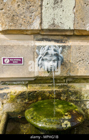 Die klassische, mit Ornamenten verzierte Brunnen, das in der ummauerten Garten in Castle Howard mit einem "Kein Trinkwasser" Schild Stockfoto