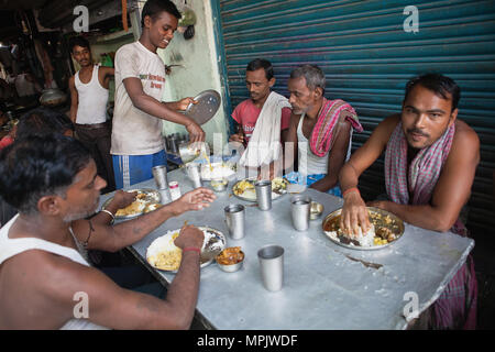 India, West Bengal, Kalkutta, Männer essen eine thali Mahlzeit aus Reis und Dal zu einem Essen Hotel. Stockfoto