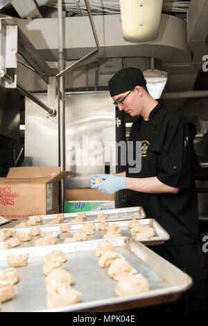 170203-N-KJ 380-024 Norfolk, Virginia (Feb. 3, 2017) Kulinarische Specialist Seaman Brandon Bayer, aus Roßkastanie, Ariz., Orte Plätzchenteig ein Kochen in der kombüse der Flugzeugträger USS Dwight D. Eisenhower (CVN 69) (IKE). Ike ist derzeit pier Seite folgenden regelmäßigen Bereitstellung in der 5. und 6. US-Flotte Arbeitsgebiete. (U.S. Marine Foto von Mass Communication Specialist Seaman Neo Greene III) Stockfoto