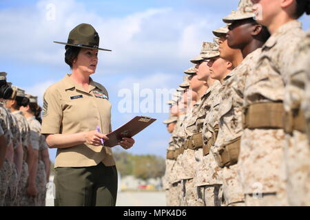 Us Marine Corps Gunnery Sgt. Tifanni Hebron, Drill Master, 4.BATAILLON, rekrutieren Training Regiment, (links) wertet eine mit Platoon 4010, 4.BATAILLON, rekrutieren Training Regiment während eines abschließenden Bohrer Bewertung auf Peatross parade Deck auf Marine Corps Depot rekrutieren, Parris Island, S.C., 22. März 2017 einzustellen. Die rekruten werden für die Bohrmaschine zählte nach Vertrauen, Liebe zum Detail und Disziplin. (U.S. Marine Corps Foto von Lance Cpl. Sarah Stegall/Freigegeben) Stockfoto