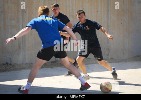 Britische Soldaten eingesetzt zur Unterstützung der Combined Joint Task Force - inhärenten lösen und die Highlanders, 4.Bataillon, das königliche Regiment von Schottland (4 Scots) Play Football team Kameradschaft und die Moral im Al Asad Air Base, Irak, 26. März 2017 zu bauen. CJTF-OIR ist die globale Koalition zu besiegen ISIS im Irak und in Syrien. (U.S. Armee Foto von Sgt. Lisa Soja) Stockfoto