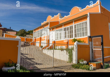 Starke orange Deutsche Historische Colonial House an einem sonnigen Tag Stockfoto