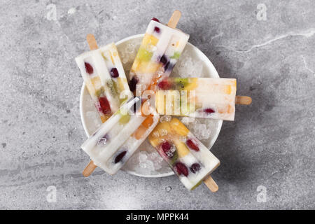 Hausgemachte Obst und Joghurt Eis am Stiel auf Marmor Stockfoto