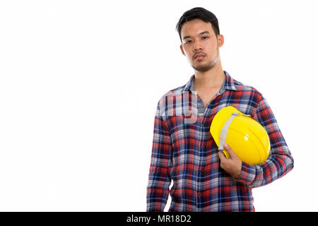 Studio shot junger asiatischer Mann Bauarbeiter holding Safet Stockfoto