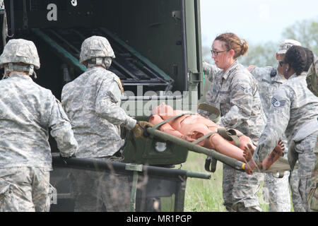 Armee-Reserve Spc. Ryan Flores und Spc. Bailey Jungmann der 469th Medical Company, Wichita, Kansas Verbünde dich mit Air Force Staff Sgt Cherrelle Warren und Flieger 1. Klasse Echo Heldreth 779th Medical Group, Macdill Air Force Base in Tampa, Florida ein Mannequin-Patient in ein M997 4 Laden Wurf HMMWV Responder Unterstützung Camp (RSC) Nighthawk, Indiana während Guardian Antwort 17 am 29. April , 2017.     Fast 5.000 Soldaten und Piloten aus über dem Land beteiligen sich an Guardian Antwort 17, einer Mehrkomponenten Übung zur Validierung der militärischen Fähigkeit, bürgerliche zu unterstützen Stockfoto