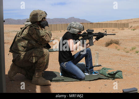 FORT BLISS, Texas - Kortni Smith, Ehefrau von Soldat 4 Bataillon zugeordnet, 27 Field Artillery Regiment, 2nd Brigade Combat Team, 1. Panzerdivision, Brände eine M4 Carbine Gewehr aus der knienden Position während Molly Pitcher Tag, 27. April 2017 in Fort Bliss, Texas. Ehegatten von 1 AD-Soldaten den Tag lernen grundlegende Soldatentum Fähigkeiten, die ein M4 Carbine Gewehr und Abseilen feuern enthalten. Molly Pitcher Tag ehrt die Arbeit einer Frau, die Wasser Krüge für Soldaten und feuerte eine Canon, nachdem ihr Ehemann während der Amerikanischen Schlacht von Monmouth zusammengebrochen. (U.S. Armee Foto b Stockfoto