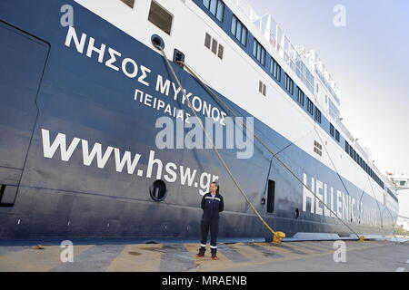 Piräus, Griechenland. 25 Mai, 2018. Theano Sileloglou steht neben Handelsschiff die 'Mykonos Insel' am Hafen von Piräus, Griechenland, 25. Mai 2018. Theano Sileloglou, 30, ist ein Mitglied der Hellenic Seaways seit 2010. Sie begann ihre Karriere als 3. Techniker an 'Mykonos Insel' Schiff im Jahr 2010 und heute ist sie eine der 1 Ingenieur. Bis vor kurzem Maschinenraum des Schiffes war ein männlich dominierten Raum. Quelle: Chris Kissadjekian/Xinhua/Alamy leben Nachrichten Stockfoto