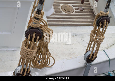 Holz- Block und Spanngeschirr festgezurrt und verstaut als Teil der Takelage auf einem Segelboot. Stockfoto