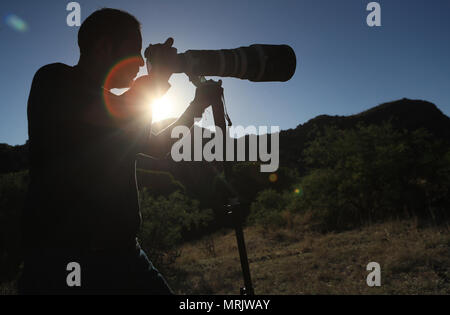 Fotograf Ruben Dario Betancourt verwendet eine 500 mm Canon F4 Objektiv und Sonnenbrille, in Cuenca los Ojos finden. Naturpark,. Sonnenuntergang, Sonne, Sonnenuntergang Stockfoto
