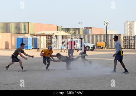 170613-N-ME 988-0594 DUQM, Oman (13. Juni 2017) Matrosen zu den Amphibischen dock Landung Schiff USS Carter Hall (LSD 50) und Marines auf den 24 Marine Expeditionary Unit zugewiesen, die in einem Captain cup Flag football Spiel während einer port Besuch teilnehmen. Carter Hall, Teil der Bataan amphibischen bereit, Gruppe, ist in die USA 5 Flotte Bereich für Maßnahmen zur Erhöhung der Sicherheit im Seeverkehr im Einsatz Verbündeten und Partnern zu beruhigen, und der Freiheit der Schiffahrt und des freien Handels in der Region erhalten. (U.S. Marine Foto von Mass Communication Specialist 1. Klasse Darren M. Moore) Stockfoto