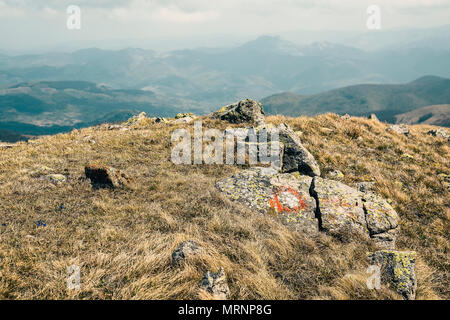 Malte Symbol auf einem Felsen Kennzeichnung ein Wanderweg auf dem Kopaonik Berg, Serbien. Rote und weiße Markierungen auf Felsen. Wegweiser für Wanderer. Farbe Effe Stockfoto