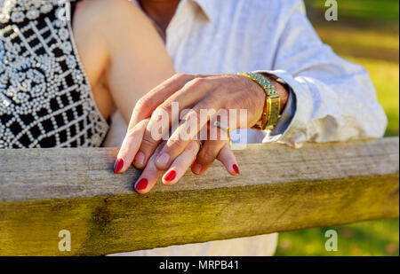 Leute, Urlaub, Engagement und Liebe Konzept - Nahaufnahme der Verlobten Hände mit Diamond Ring über Feiertage lichter Hintergrund Stockfoto