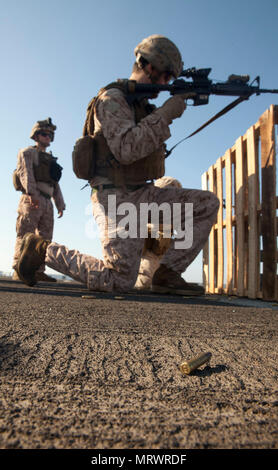 Eine Marine zu Light Armored Reconnaissance Bataillon Landung Unternehmen, Team, 3 Bataillon 6 Marines zugeordnet, bereitet seine M4 Carbine, bevor sein Ziel bei einem Schießplatz auf Waffen Kenntnisse an Bord der Flight Deck der San Antonio-Klasse amphibious Transport dock Schiff USS Mesa Verde LPD (19) 11. Juli 2017 gerichtet zu laden. Die 24 Marine Expeditionary Unit ist mit dem Bataan Amphibious Ready Gruppe unterwegs in der Unterstützung der Maritime Security Operations und Theater Sicherheit Zusammenarbeit in den USA 6 Flotte Bereich der Operationen. (U.S. Marine Corps Foto von Gunner Stockfoto