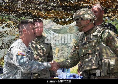 Us-Armee Generalmajor John Gronski, Stellvertretender Kommandierender General, Army National Guard, der U.S. Army Europe, spricht mit den Soldaten des 5.BATAILLON, 113 Field Artillery Regiment im Feld und mit rumänischen Militär Mitglieder in ihren Campingplatz. (U.S. Army National Guard Foto von Sgt. Odaliska Almonte, North Carolina National Guard Public Affairs/Freigegeben) Stockfoto