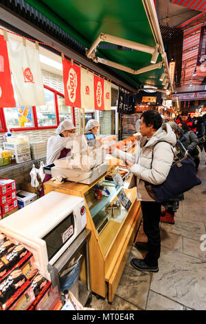 Indoor Omicho Ichiba, Omicho Markt, dem größten Markt mit frischen Lebensmitteln in Kanazawa, Japan. Blick entlang Essen mit Kunden Kauf am Schalter. Stockfoto