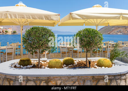 Tropische Pflanzen in kleinen Restaurant mit Meerblick. Symi Insel. Griechenland Stockfoto