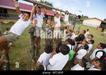 Die Task Force Koa Moana 17 war eine US-Marine-Einheit im Pazifischen Ozean, die 2017 durchgeführt wurde. Am 20. Juli 2017 unterstützten Marines Kinder bei körperlichen Übungen in einer Grundschule auf Tongatapu Island, Tonga, während Freiwilligenaktivitäten im Zusammenhang mit der Mission. Das Archivbild dokumentiert das Engagement der Gemeinschaft während der TAFAKULA-Periode. Stockfoto